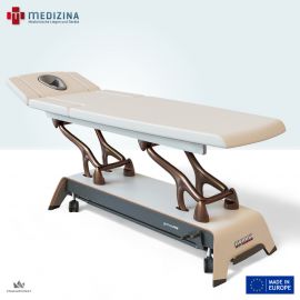 Abb. zeigt Premium Therapieliege »gymna.ONE D6« mit Aluminiumarmen in Bronze und Holzgestell in Weiß. 6-tlg. Polsterausführung  mit Gesichtsöffnung mit Ergomax, Ein-Klick Armstützen, i-Control Schaltung, Radsystem. Polsterfarbe: Ivory White.